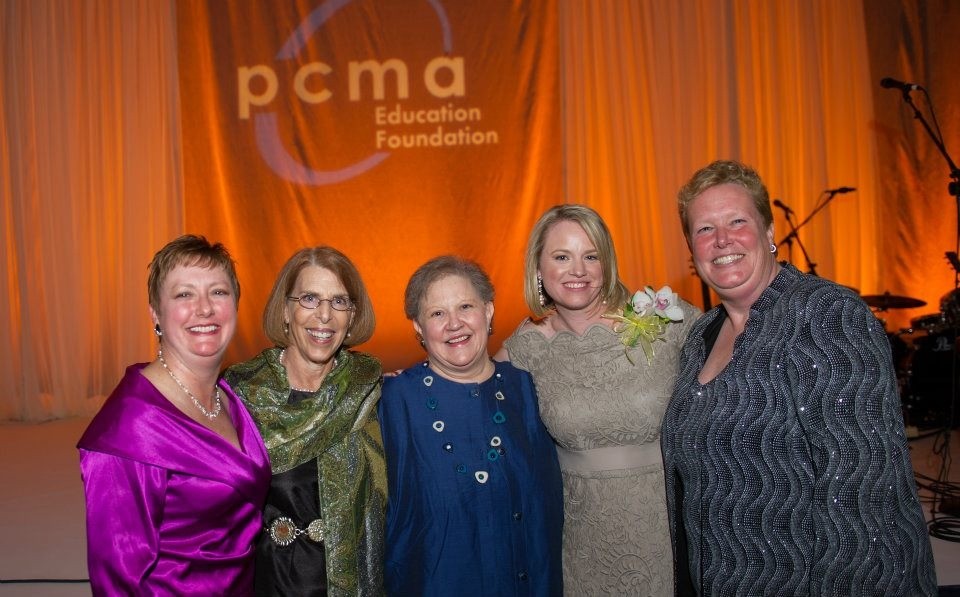 Photo of Joan Eisenstodt standing with meetings industry friends at a PCMA Education Foundation event.
