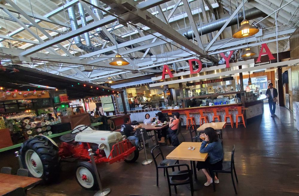Anaheim Packing District dining area with a red and white tractor.