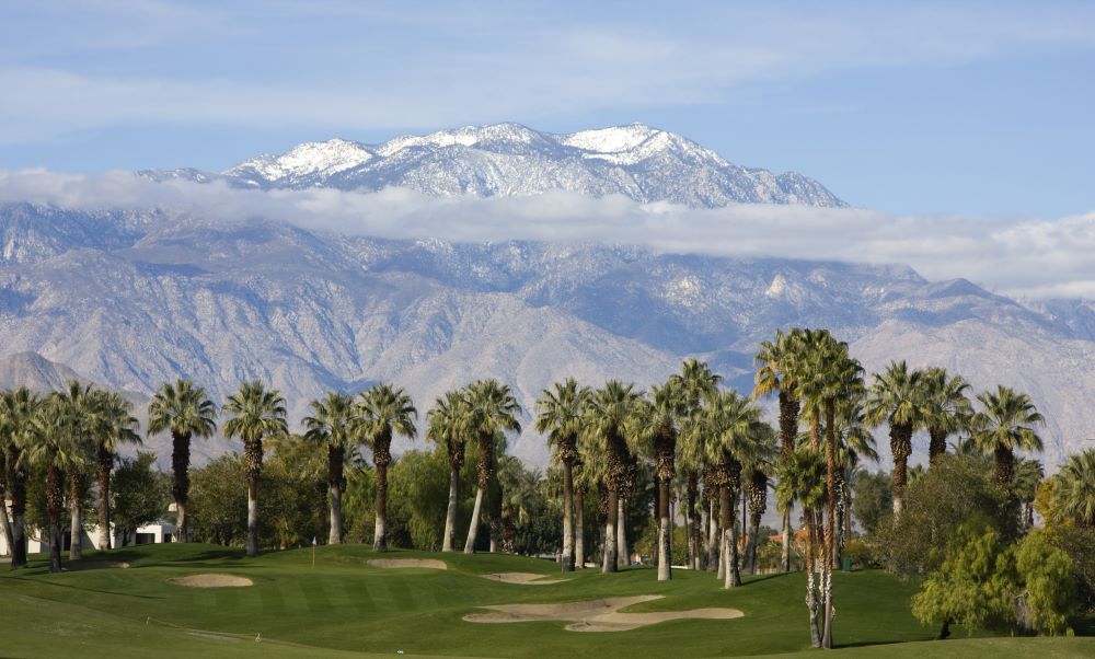 Photo of Palm Springs with snow capped mountains in the background.