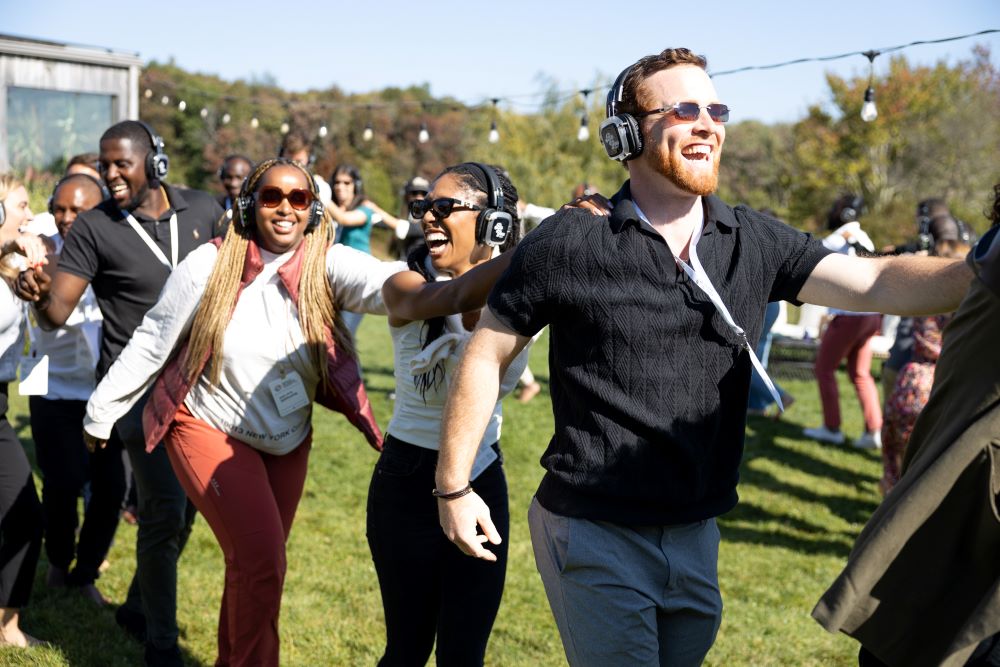 Participants form a conga line during a Be You Disco experience