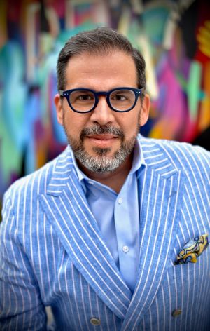 Peter Gamez, in a blue pin-striped suit.