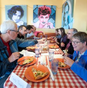Photo of people eating pizza during a Desert Tasty Tours program at Bill’s Pizza, Palm Springs.