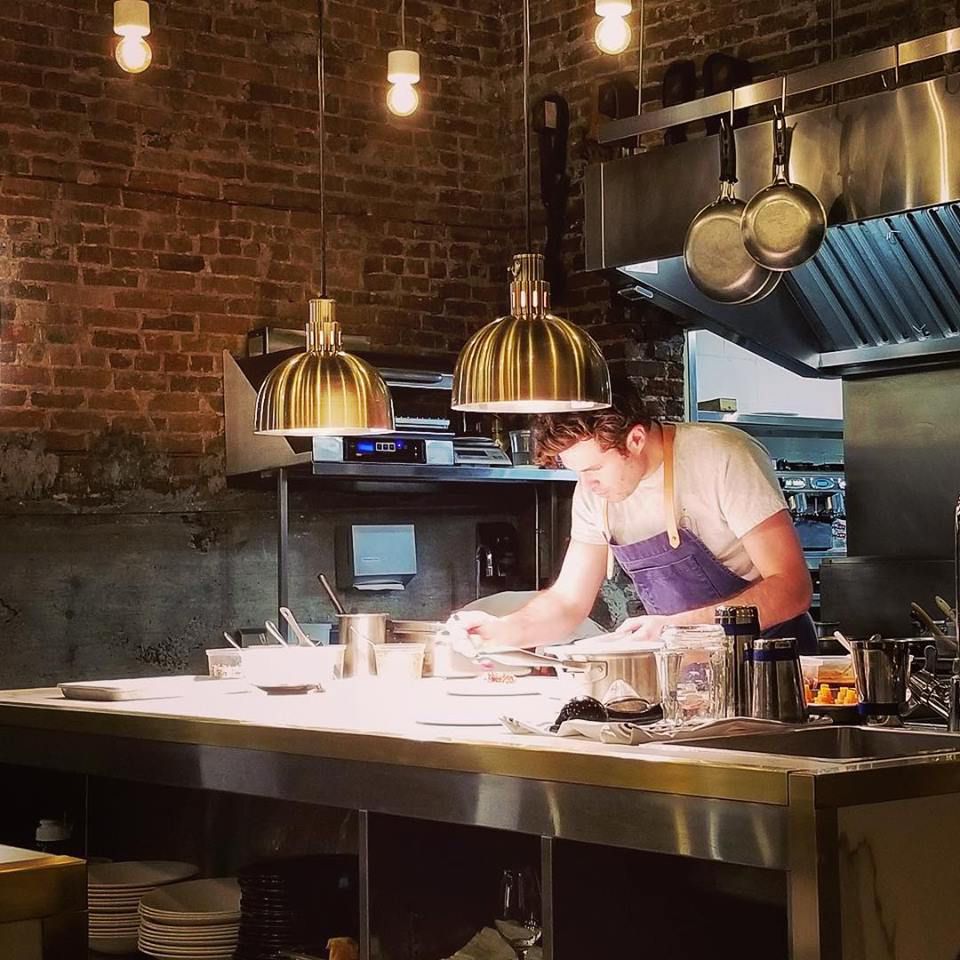 Photo of a chef working over a table at ARVI.