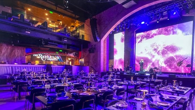 Photo of The Rayleigh Underground set up for a banquet, bathed in purple light.