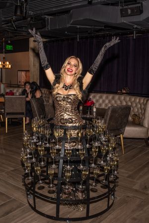 Photo of a woman wearing at champagne dress at Rayleigh Underground Toyota Music Factory.
