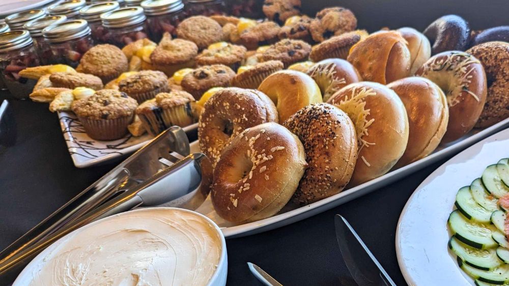 Photo of a table with bagels and pastries.