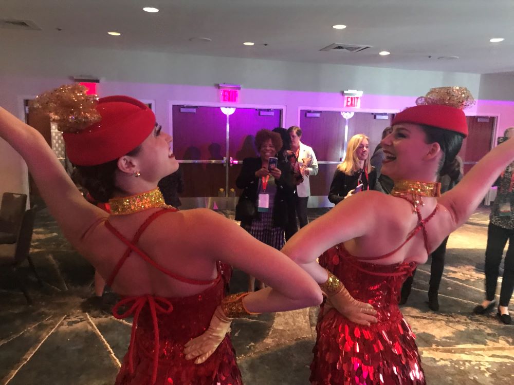 Performers greet SITE Global Conference attendees as they arrive for the opening reception.