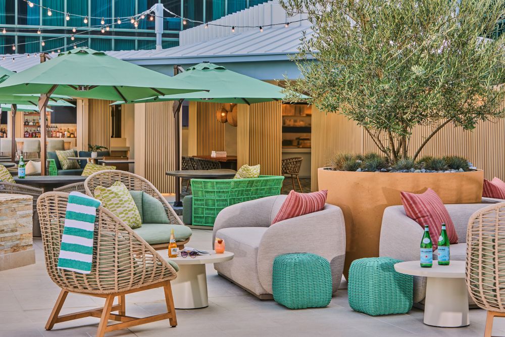 Rooftop terrace at Hilton Anaheim, with comfy outdoor chairs and cabanas.