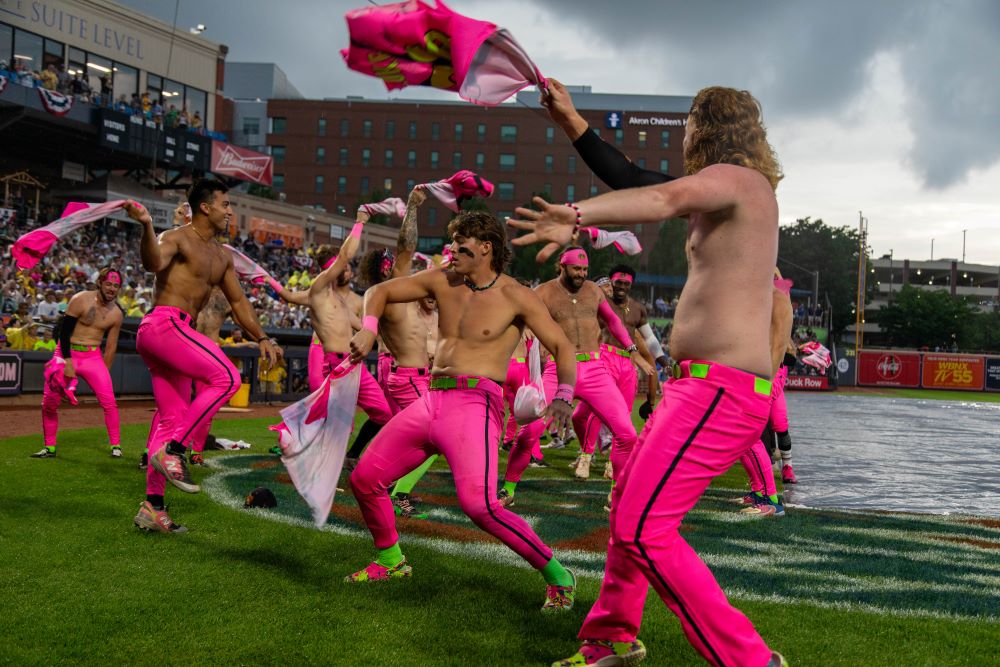 Photo of Savannah Bananas baseball team dancing with their shirts off,