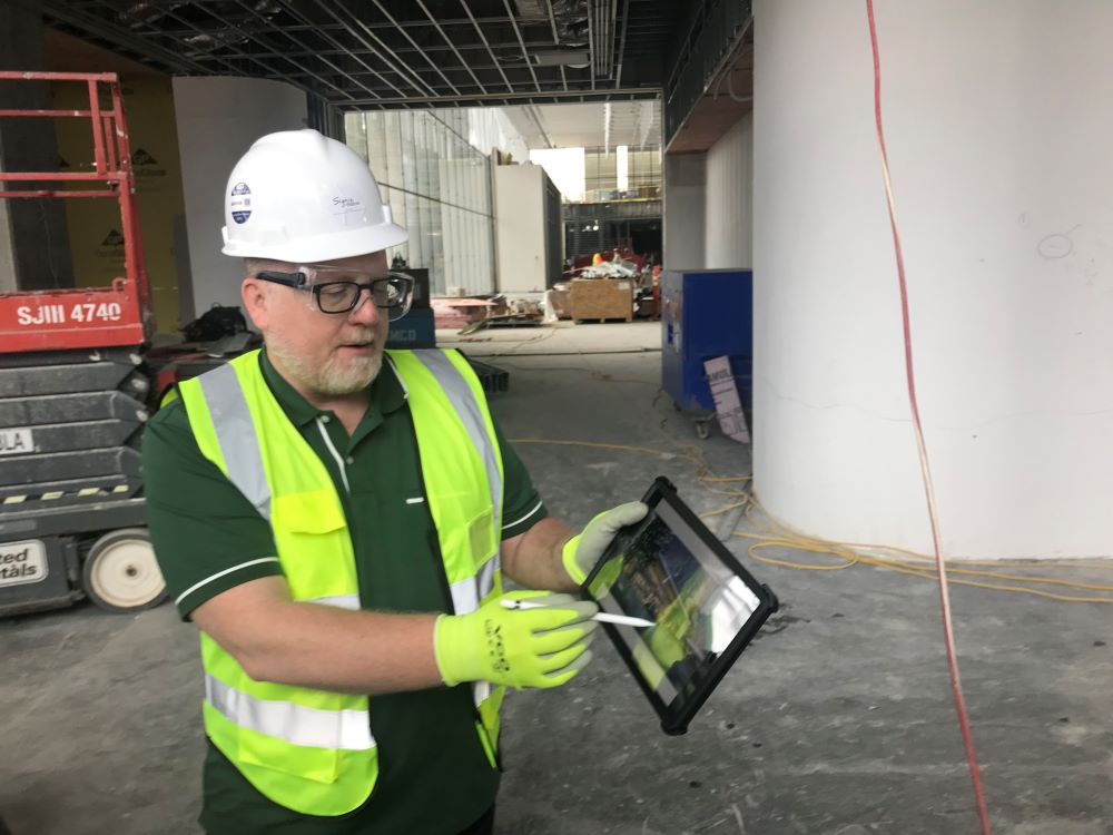 Photo of Kenny Monteith, Senior Marketing Manager, leading tour of Signia by Hilton Atlanta construction site.