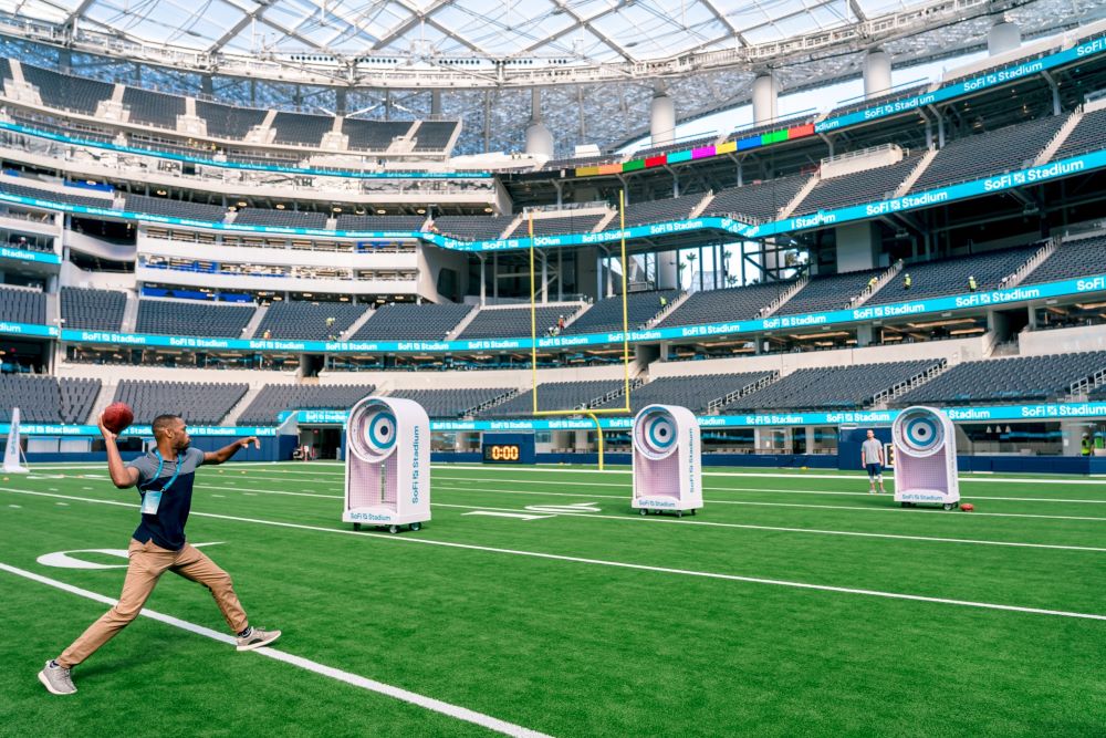 Attendee throwing a football at SoFi Stadium