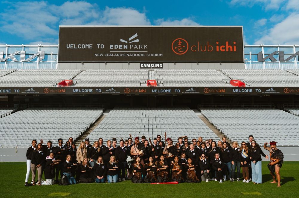 Eden Park, in New Zealand, with people posing on the field