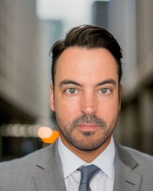 Photo of Stewart Mann in a grey suit.