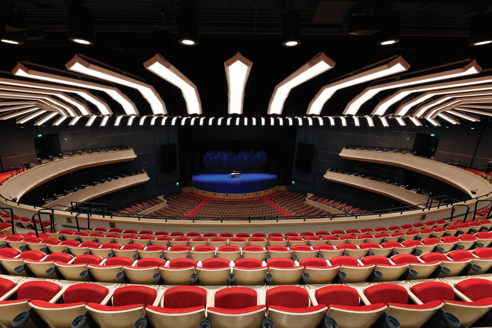 Photo of seating in Tanger Center for the Performing Arts, with rows of empty red seats.