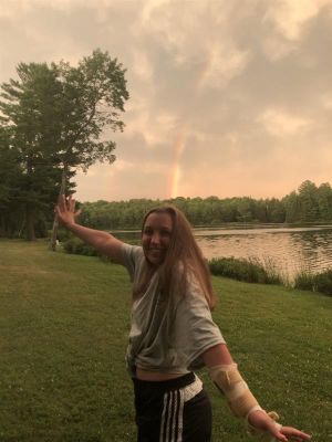 Taylor in front of a rainbow after a storm