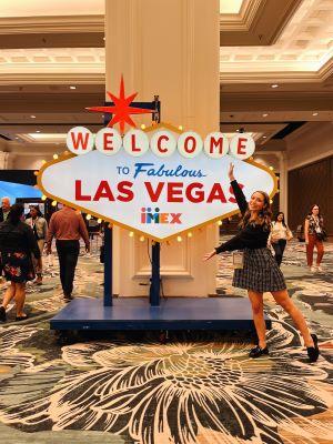 Taylor posing with the IMEX Las Vegas sign