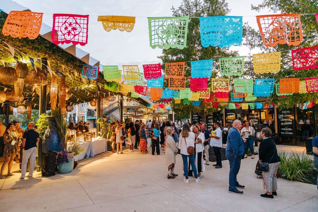 Photo of people gathered at The Creamery, with colorful art hanging above.