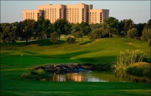 Photo of exterior of The Ritz-Carlton, Dallas at Las Colinas, with a gold course in the foreground.