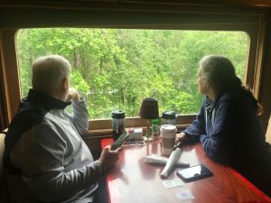 Photo of two people seated and looking out the window during Great Smoky Mountain Railroad Experience excursion.