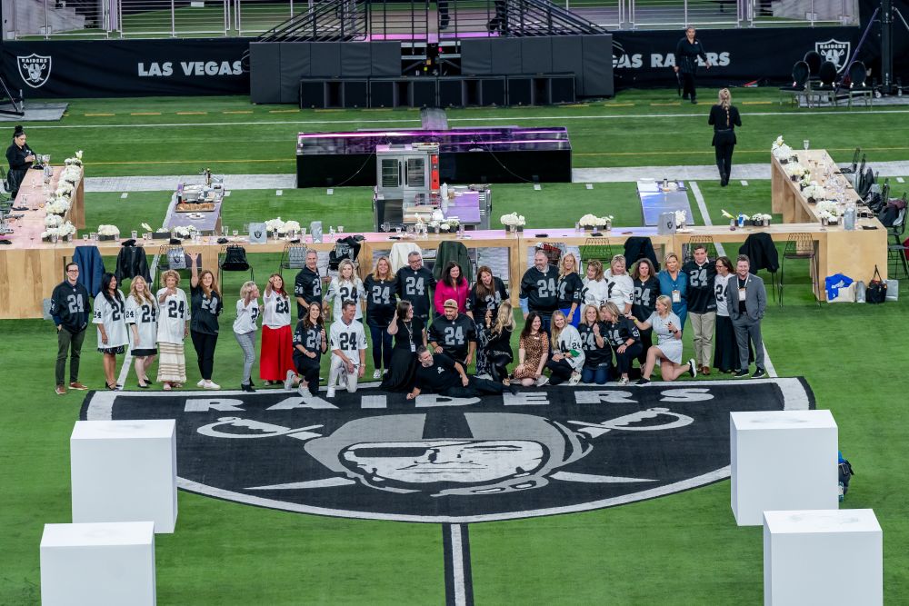 Brand Experience Summit attendees in Las Vegas football team jerseys gathered for on-field dinner 