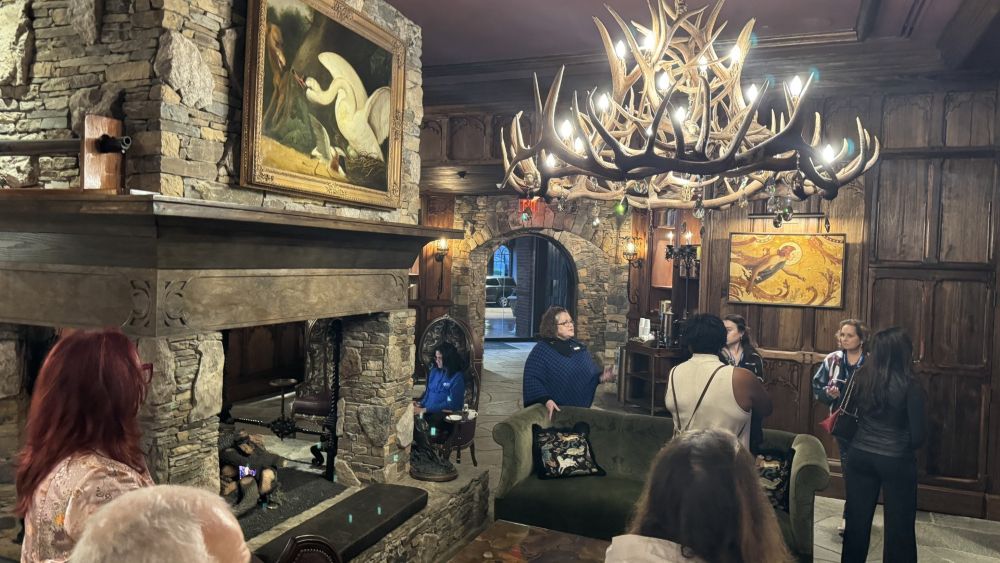 Tour of the Grand Bohemian hotel in Asheville, with an antler chandelier in the background.