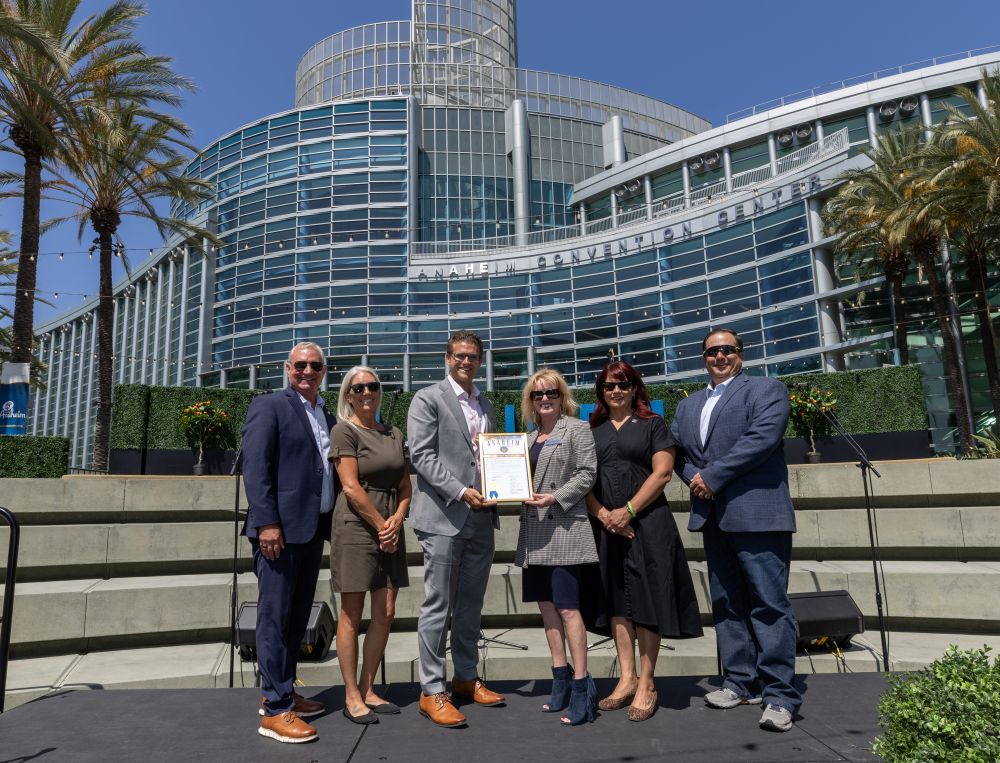 Photo of a group of people standing with a proclamation in front of the Anaheim Convention Center.