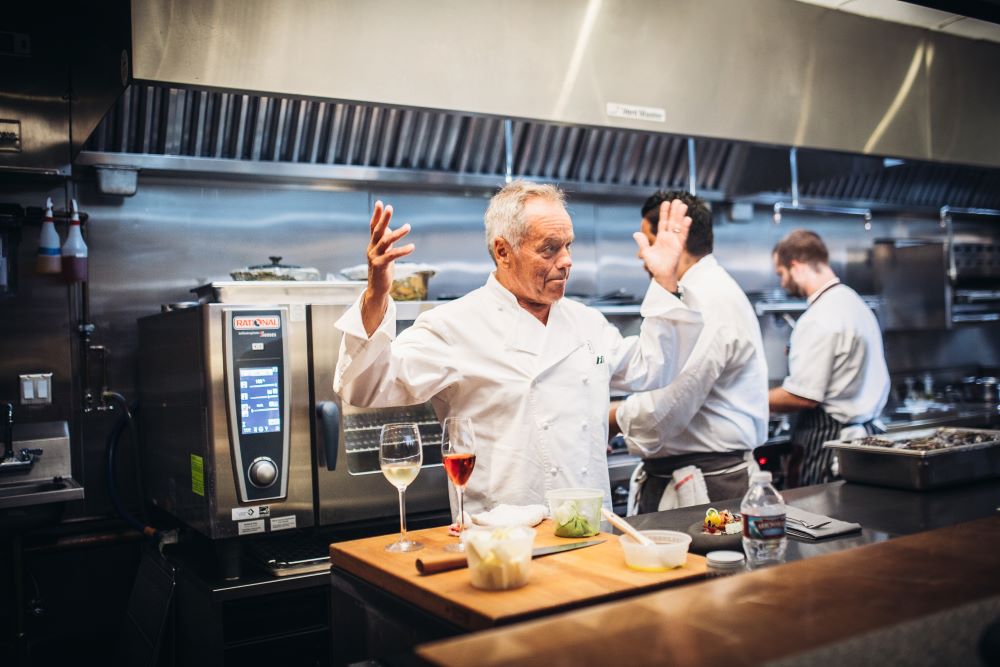 Photo of Wolfgang Puck in the kitchen.