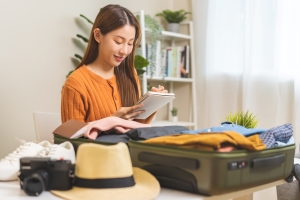 Woman Writing Luggage Packing List