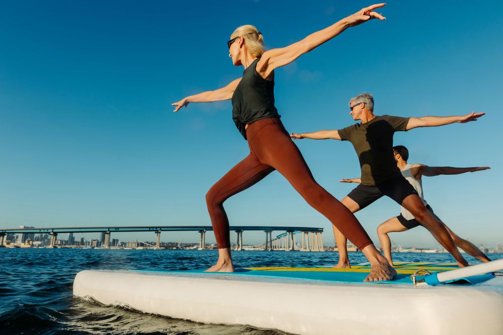 Photo of people practicing yoga on the water