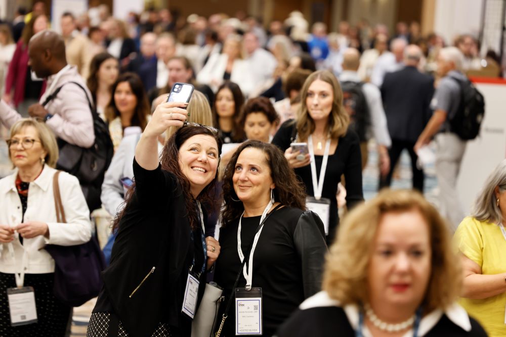 Attendees take a selfie at IMEX America 2022