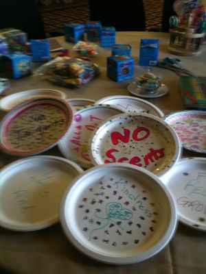 Photo of a number of paper plates with writing on them.