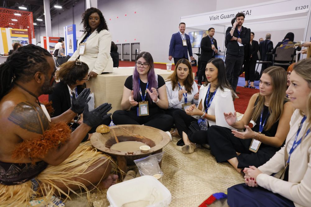 Group of attendees gathered in a circle at IMEX America 2024.