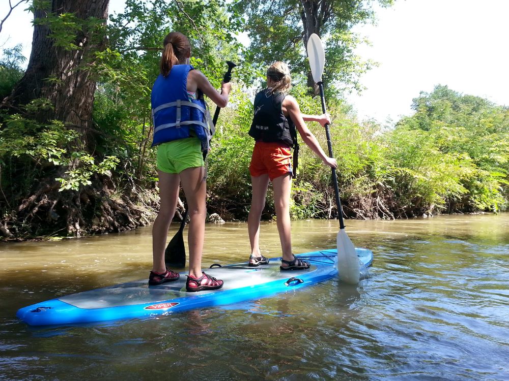 Two women paddleboarding in Kearney, Nebraska