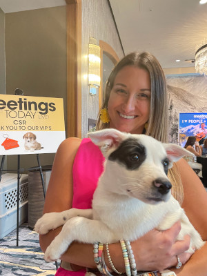 Meetings Today LIVE! attendee holds a puppy