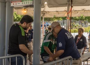 Photo of people going through a metal detector.