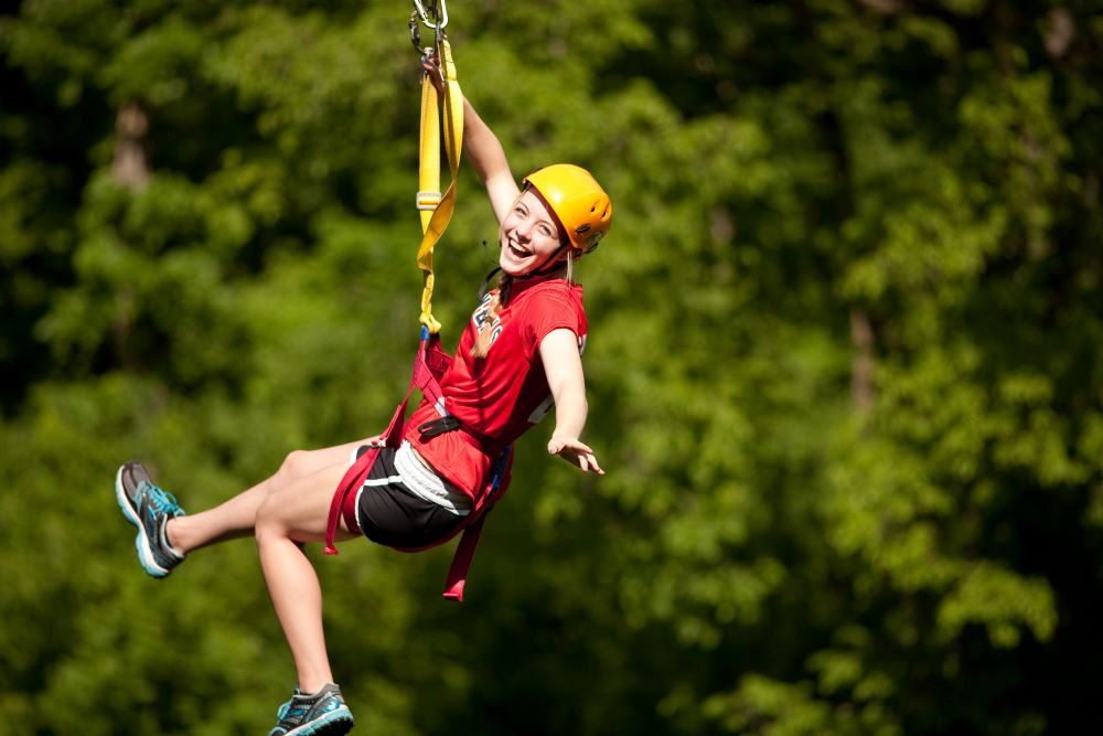 Woman ziplining with Sky Tours