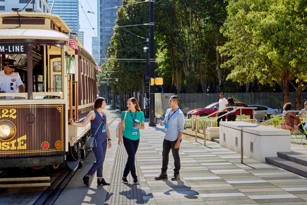 Meeting attendees outside of the trolley in downtown Dallas