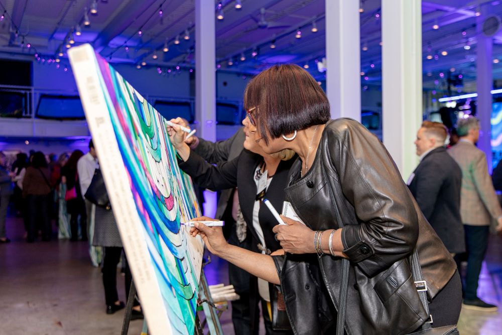 Interactive painting activity at an event at Artists for Humanities EpiCenter
