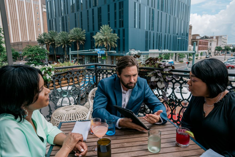 Three attendees sitting at a table