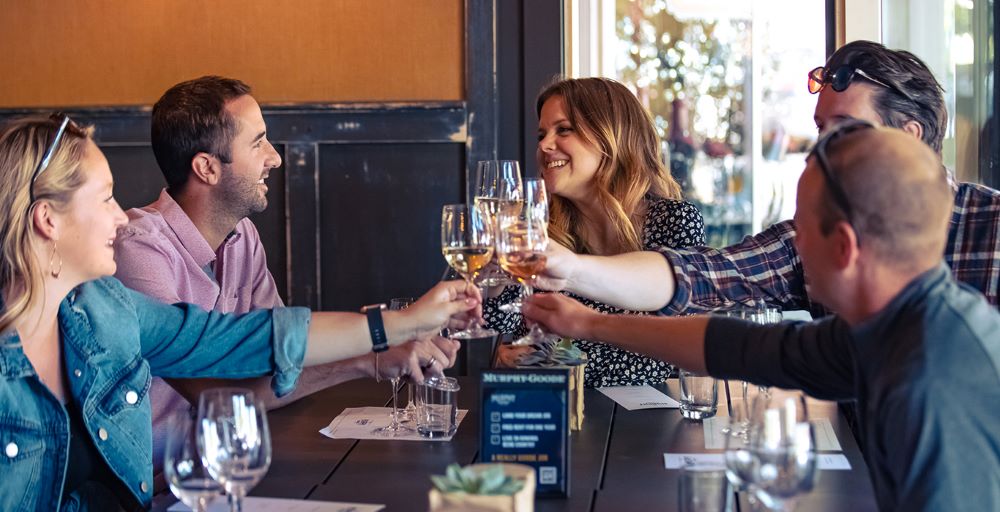 A group of four people doing a cheers with wine glasses in Healdsburg
