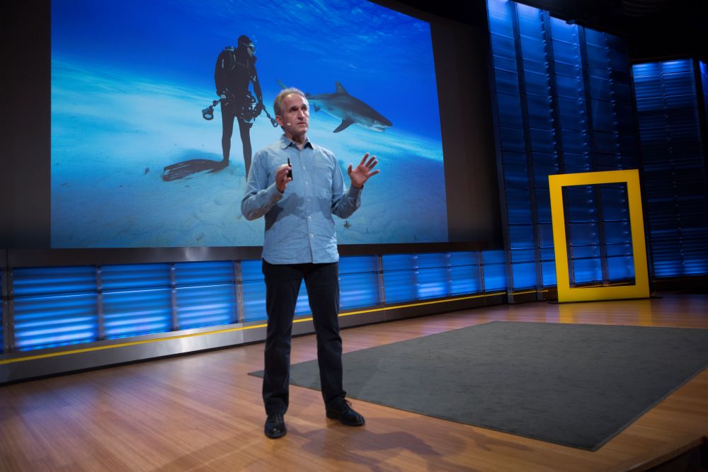 Brian Skerry speaking in front of a screen