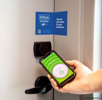 image of mobile phone next too door handle and a sticker sealing the door.