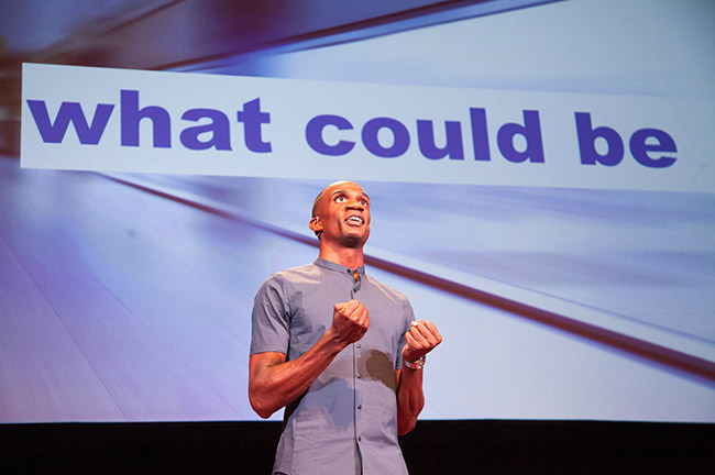 Lex Gillette Onstage During a Speaking Engagement