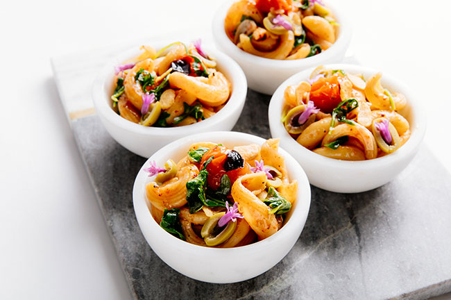 Torchio Pasta With Arugula and Oven-Dried Cherry Tomatoes, Credit: Wolfgang Puck Catering