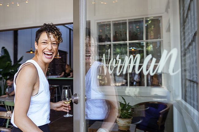 ​Dana Frank Enjoying Wine Outside of Bar Norman, Credit: Chris Corbin