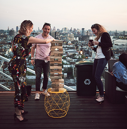 Group Playing Giant Jenga at the Turf Club Rooftop Bar at Westlight, Brooklyn, New York