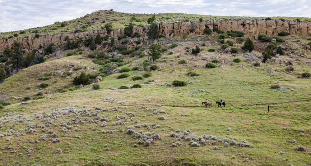 Horseback riders crossing the countryside