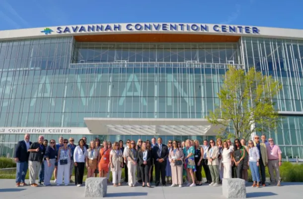 Photo of Savannah convention center and DMO community gathered in front of the expanded Savannah Convention Center.