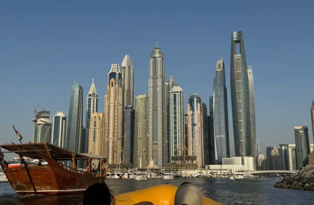 Photo of the skyline of Dubai from a boat on the water.
