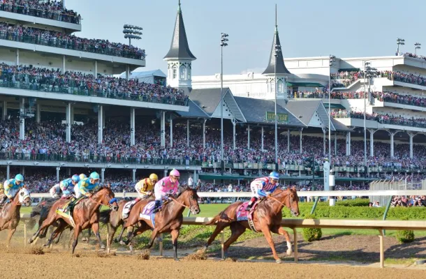 Photo of thoroughbred horses rounding at turn at Churchill Downs during the Kentucky Derby.
